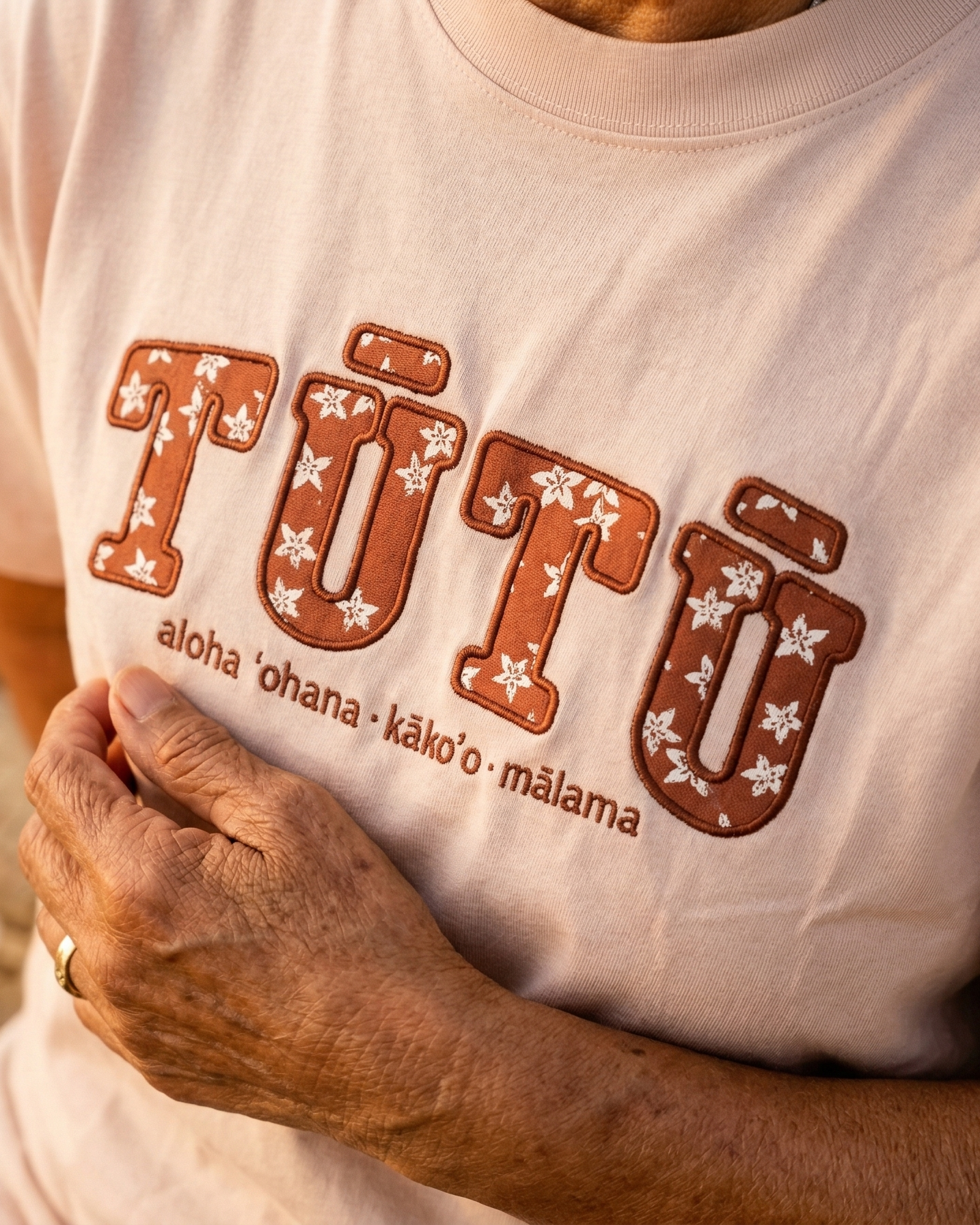 Hawaiian woman grandma wearing a light pink tutu shirt. Hawaiian affirmation apparel.