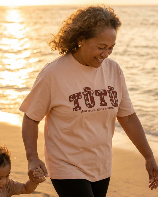 Hawaiian woman grandma wearing a light pink tutu shirt. Hawaiian affirmation apparel.